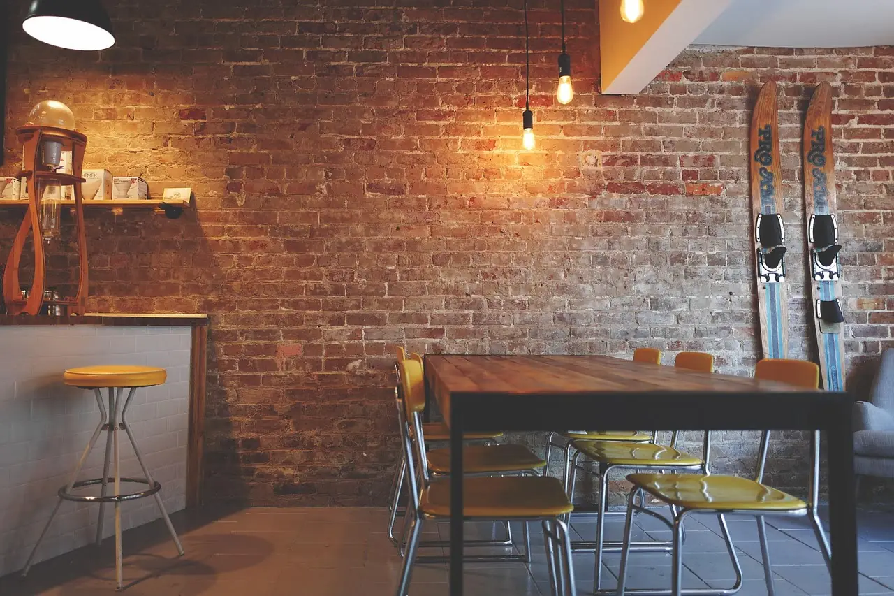 Warm brick shop interior with a long communal table