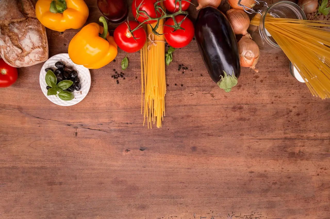 Styled pantry goods and produce photographed on a wooden table